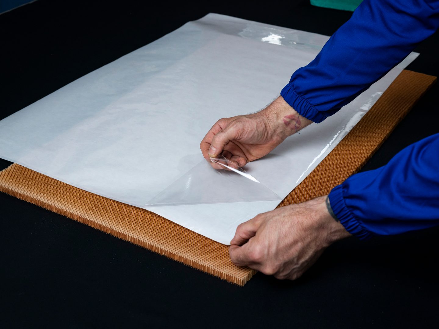 AVIOREC operator applying MNL367AVC to a honeycomb panel